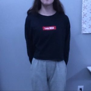 Navy blue long sleeve crop top wording “love wins”